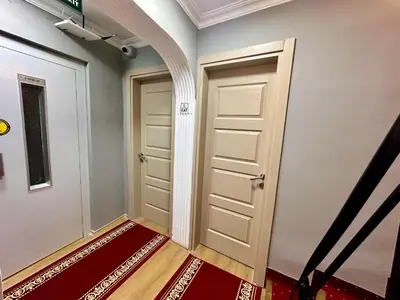 a hallway with a door and a red rug at Crowned Exclusive Hotel in Istanbul