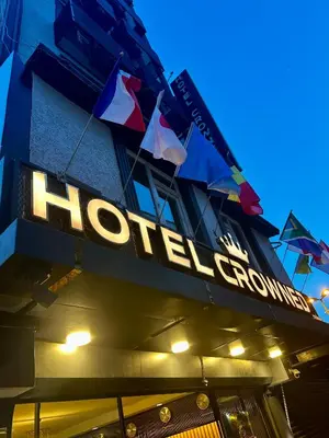 a hotel sign on the side of a building with flags at Crowned Exclusive Hotel in Istanbul