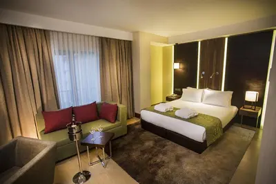 a hotel room with a bed and a couch at Ramada by Wyndham Istanbul Florya in Istanbul