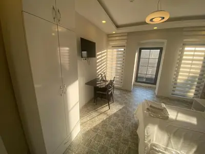 a bedroom with a desk and a bed and a table at The Red Tent Loft Suites in Istanbul