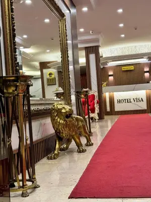 a golden lion statue in a hotel lobby with a mirror at Hotel Visa in Istanbul