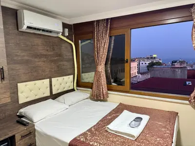 a bedroom with a bed and a large window at Hotel Visa in Istanbul