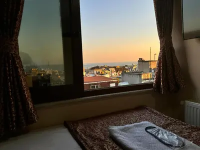 a bed in a room with a large window at Hotel Visa in Istanbul