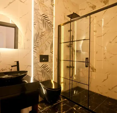 a bathroom with a glass shower and a sink at Yakut Hotel in Istanbul