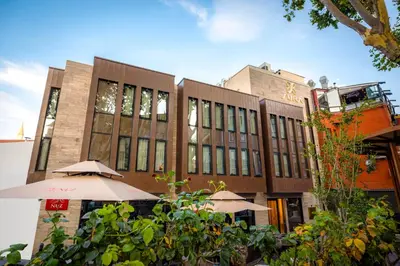 a building with two umbrellas in front of it at Sura Concept Hotel in Istanbul