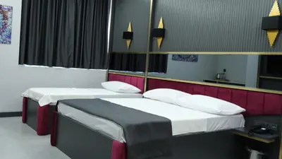 two beds in a small room with red and black at 216 Prestige Hotel in Istanbul