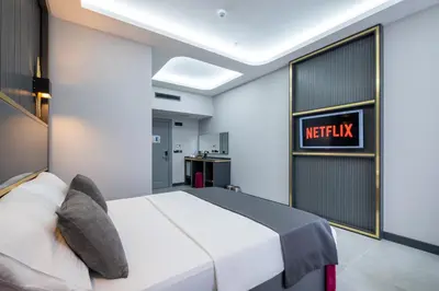 a bedroom with a white bed and ametix sign on the wall at 216 Prestige Hotel in Istanbul