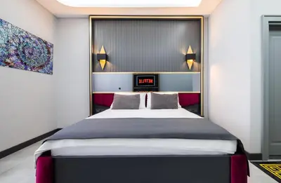 a bedroom with a bed with a clock on the wall at 216 Prestige Hotel in Istanbul