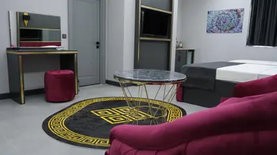 a living room with a table and a bed at 216 Prestige Hotel in Istanbul