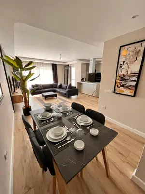 a living room with a black table and chairs at Sense Suite Residence-KAPALI in Istanbul