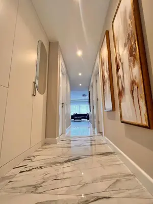 a hallway with marble flooring and a hallway with a pool at Sense Suite Residence-KAPALI in Istanbul