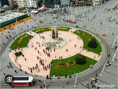 a group of people walking around a plaza with a fountain at The Now Hotel in Istanbul
