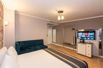 a hotel room with a bed and a flat screen tv at The Now Hotel in Istanbul