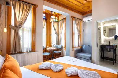 a bedroom with a bed and a table and a mirror at The Astra Hotel in Istanbul