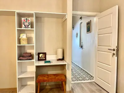 a walk in closet with a white door and a stool at BOHO HOUSE Istanbul in Istanbul