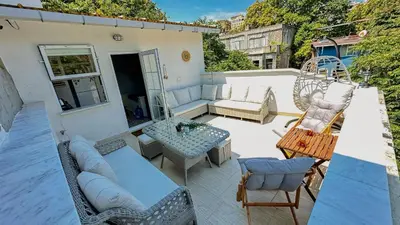 a patio with a couch and a table and chairs at BOHO HOUSE Istanbul in Istanbul