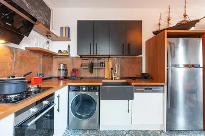 a kitchen with a washer and dryer in it at Panoramic Sea View Loft with Terrace BBQ in Istanbul