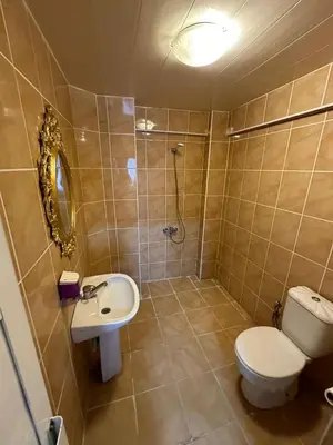 a bathroom with a toilet and a sink and a shower at Hotel Metropol 1 in Istanbul