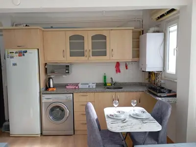 a small kitchen with a table and a refrigerator at Sultanahmet Apartment in Istanbul