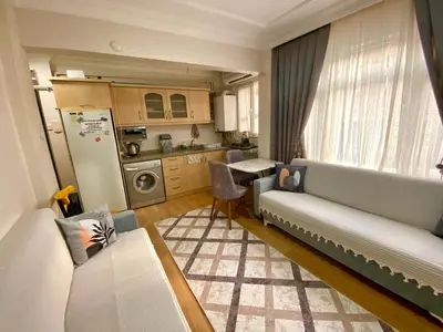 a living room with a couch and a kitchen at Sultanahmet Apartment in Istanbul