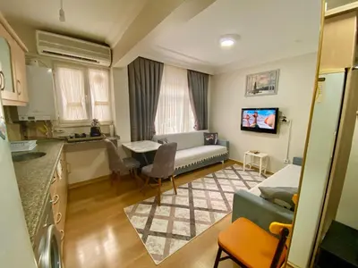 a kitchen and living room with a couch and a table at Sultanahmet Apartment in Istanbul