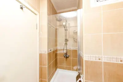a bathroom with a shower and a bath tub at Qbra House in Istanbul
