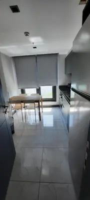 a kitchen with a table and a dining room at NEW Modern Central 2BR 2BA in Istanbul