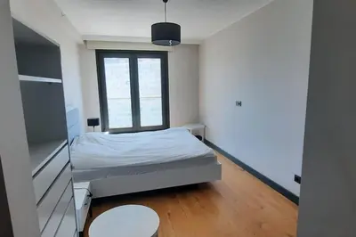 a small bedroom with a bed and a window at NEW Modern Central 2BR 2BA in Istanbul