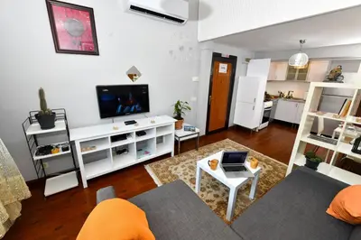 a living room with a couch and a tv at The Maiden Tower From Your Bedroom Romantic View, In Taksim Square in Istanbul