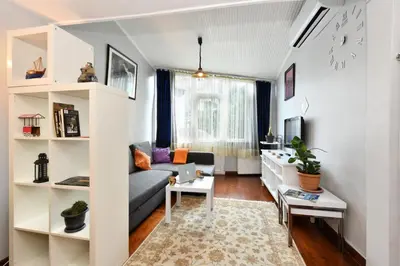 a living room with a couch and a table at The Maiden Tower From Your Bedroom Romantic View, In Taksim Square in Istanbul
