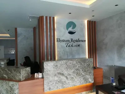 a woman sitting in front of a sign on a wall at Luxury Residence in Taksim in Istanbul
