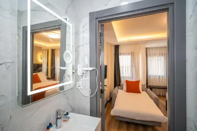 a bathroom with a sink and a mirror at Robin Hotel in Istanbul