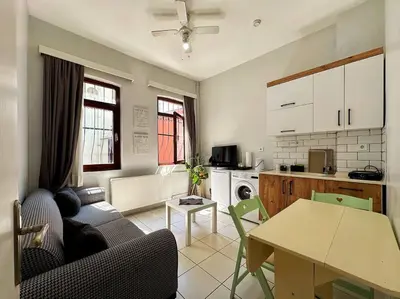 a living room with a table and a kitchen at Triplex in Taksim Square with 4 Bedroom in Istanbul