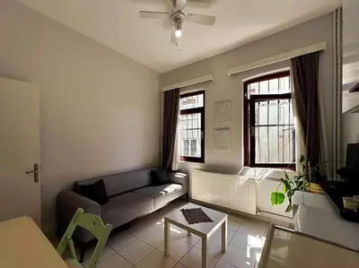 a living room with a couch and two windows at Triplex in Taksim Square with 4 Bedroom in Istanbul