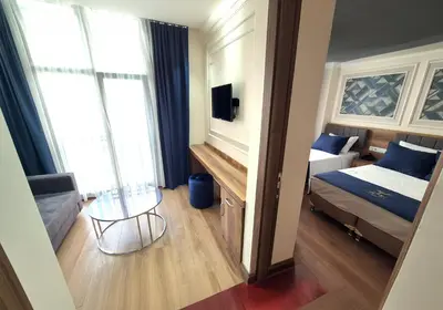 a bedroom with a bed and a table in a room at New Fors Hotel in Istanbul