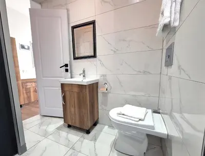 a white bathroom with a sink and a toilet at New Fors Hotel in Istanbul