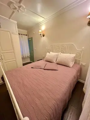 a bedroom with a large bed with a pink blanket at Konak Maksem in Bursa