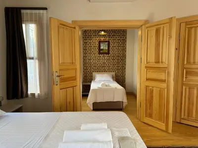a bedroom with two beds and a brick wall at HanFlats in Istanbul