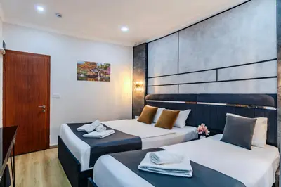 a hotel room with two beds and a door at La Pazza Suites in Istanbul