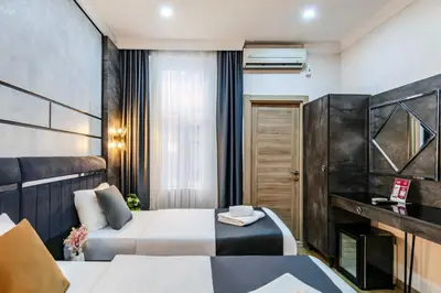 a hotel room with two beds and a fireplace at La Pazza Suites in Istanbul