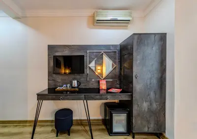 a desk in a room with a wall with a mirror at La Pazza Suites in Istanbul