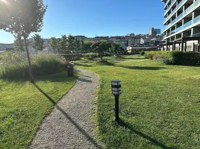 a parking meter in the grass near a building at Modern Luxury apt at Sinpas Queen in Istanbul