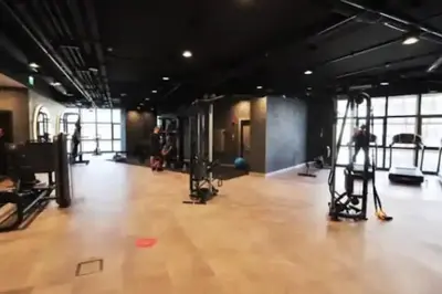 a gym with a wooden floor and equipment in a room at Modern Luxury apt at Sinpas Queen in Istanbul