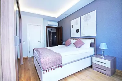 a bedroom with a white bed and a blue wall at Excellent Apartments Fatih Serenity in Istanbul