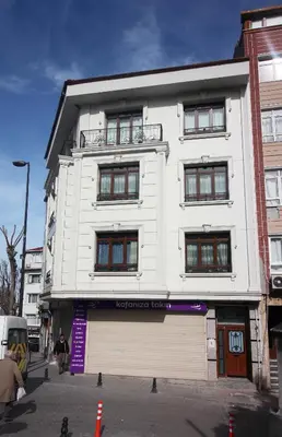 a white building with a garage in front of it at Excellent Apartments Fatih Serenity in Istanbul
