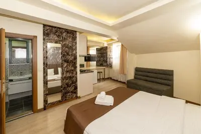 a hotel room with a bed and a kitchen at taksim terra suit 2 in Istanbul