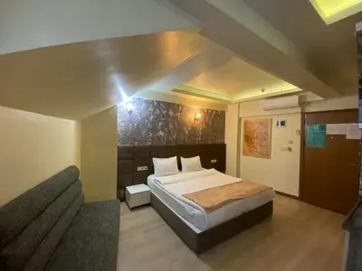 a hotel room with a bed and a couch at taksim terra suit 2 in Istanbul