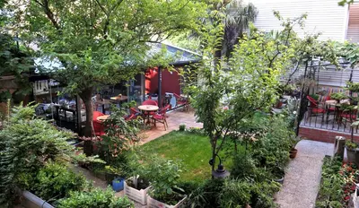 a garden with a table and chairs and trees at Ottoman Suites by Sera House in Istanbul