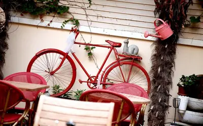 a red bike parked next to some tables and chairs at Ottoman Suites by Sera House in Istanbul