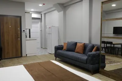 a living room with a couch and a kitchen at Tavra Daltaban in Istanbul